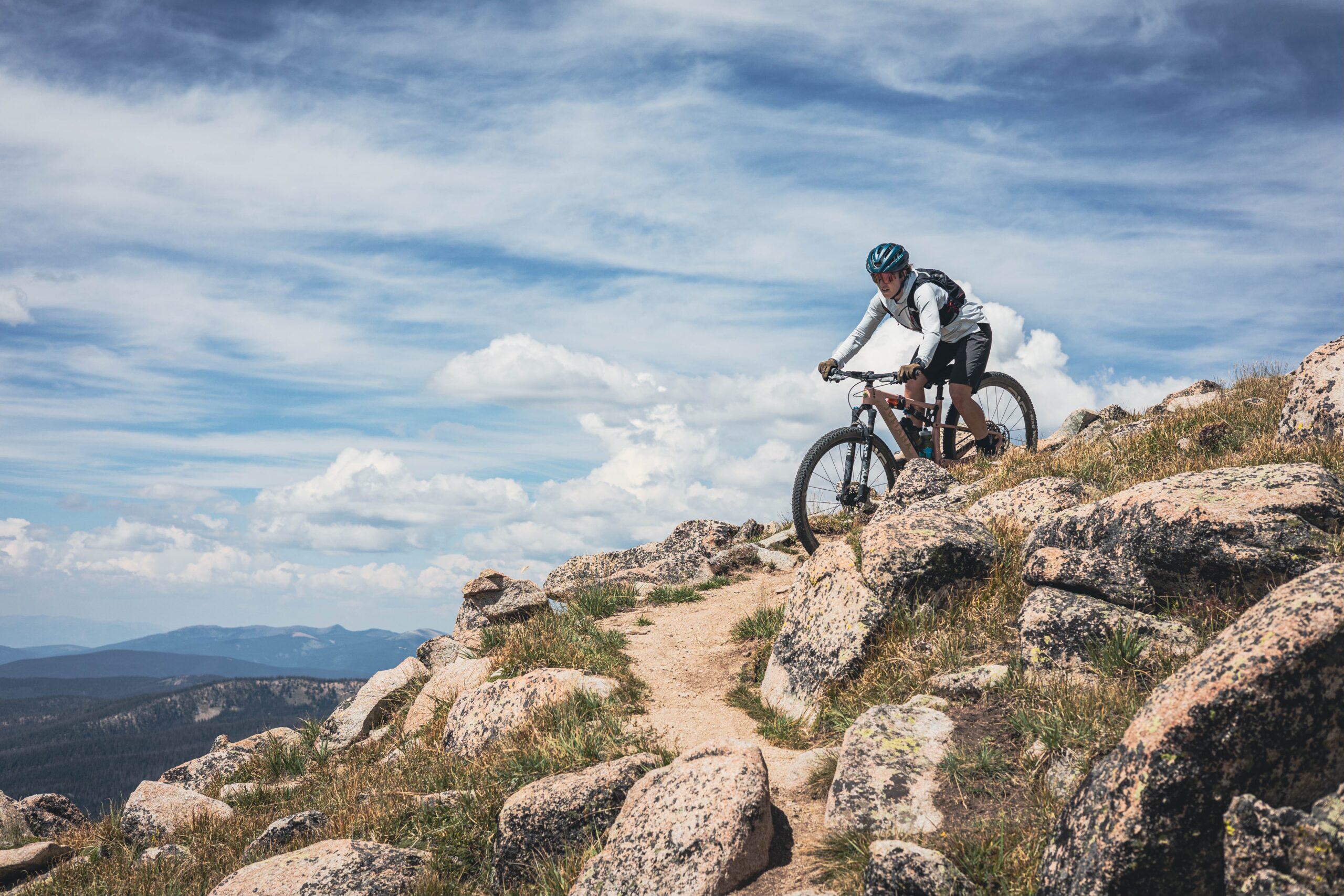 Mountain Games Athlete Haley Dumke rides her bike through a scenic mountain trail